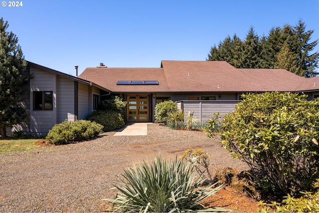 single story home with solar panels