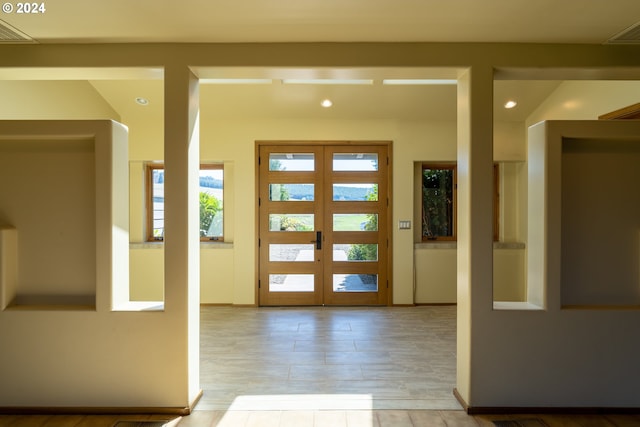 entryway featuring french doors and light wood-type flooring