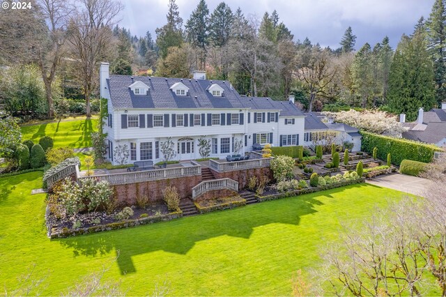 rear view of property with a lawn