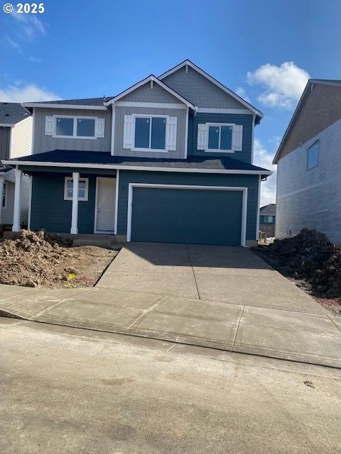 view of front of home with a garage, driveway, and board and batten siding