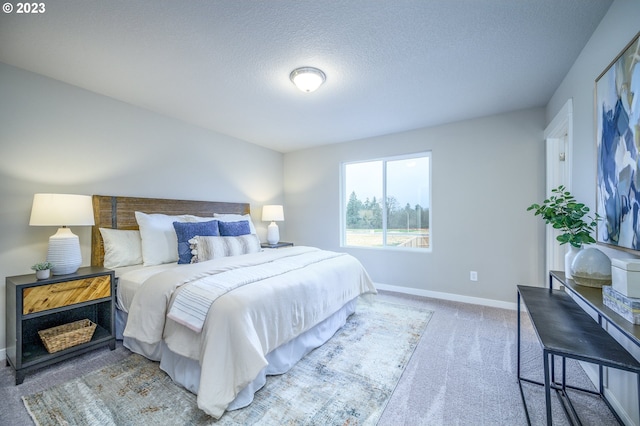 bedroom with carpet flooring and a textured ceiling