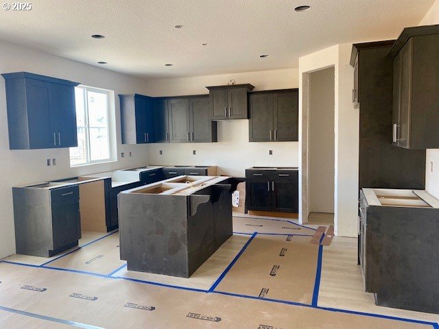 kitchen featuring a kitchen island and a textured ceiling