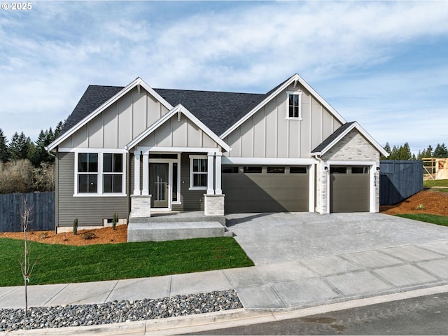 modern farmhouse featuring fence, board and batten siding, and a shingled roof