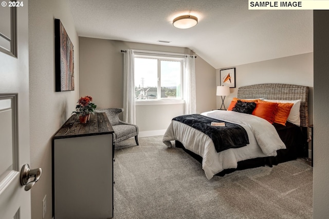 carpeted bedroom with a textured ceiling and lofted ceiling