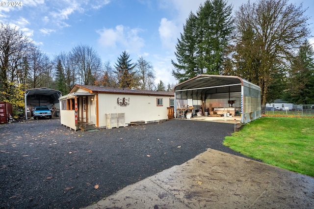 exterior space with a carport and a yard