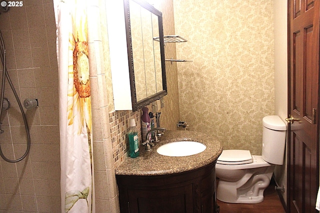 bathroom featuring vanity, decorative backsplash, toilet, and a shower with shower curtain