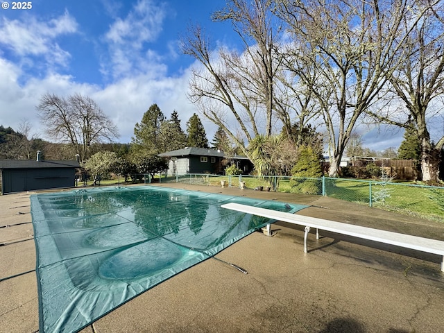 view of pool featuring a diving board