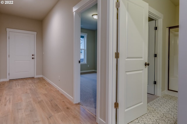 hallway with light colored carpet