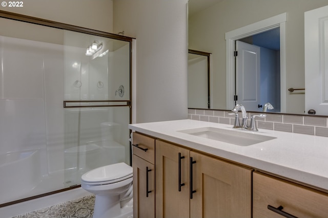 bathroom featuring decorative backsplash, vanity, an enclosed shower, and toilet