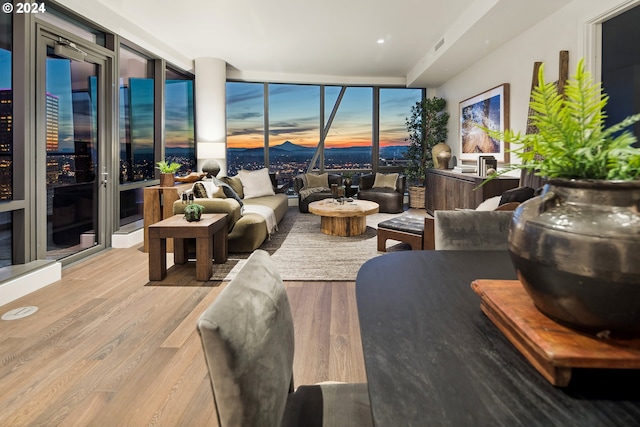 living room featuring light hardwood / wood-style flooring and floor to ceiling windows