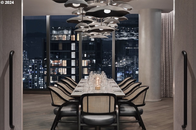 wine area with bar area, hardwood / wood-style floors, and a chandelier