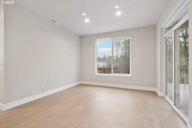 unfurnished bedroom with dark colored carpet, connected bathroom, a tray ceiling, and multiple windows