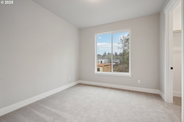 unfurnished bedroom with a spacious closet, a closet, and carpet