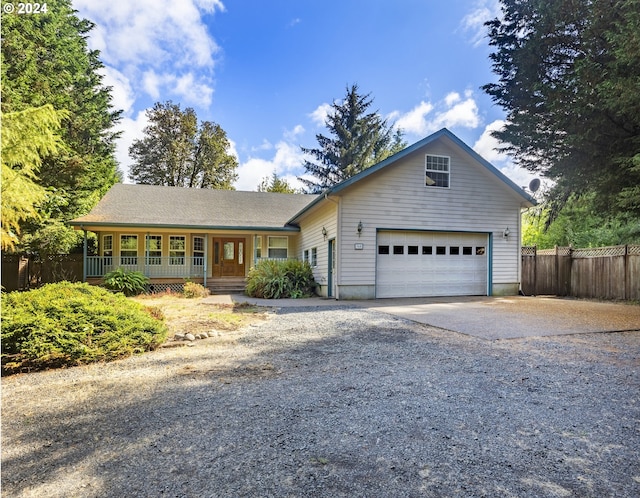 ranch-style home featuring covered porch and a garage