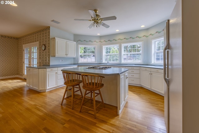 kitchen with a kitchen island, stainless steel appliances, and a wealth of natural light