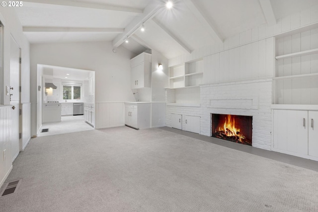 unfurnished living room featuring light carpet, built in features, a fireplace, and lofted ceiling with beams