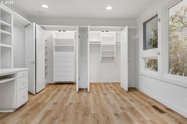 spacious closet featuring light wood-type flooring