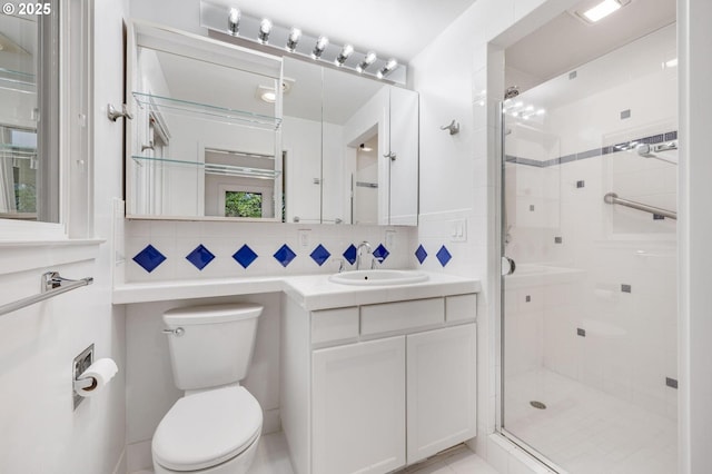 bathroom featuring toilet, tasteful backsplash, an enclosed shower, and vanity