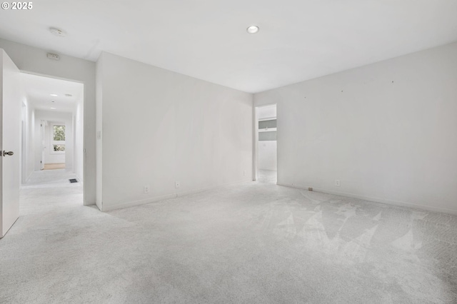 unfurnished room featuring light carpet