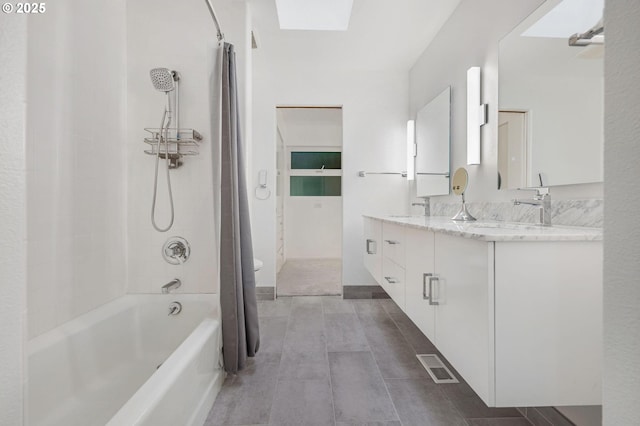 full bathroom with toilet, a skylight, shower / bath combo, and vanity