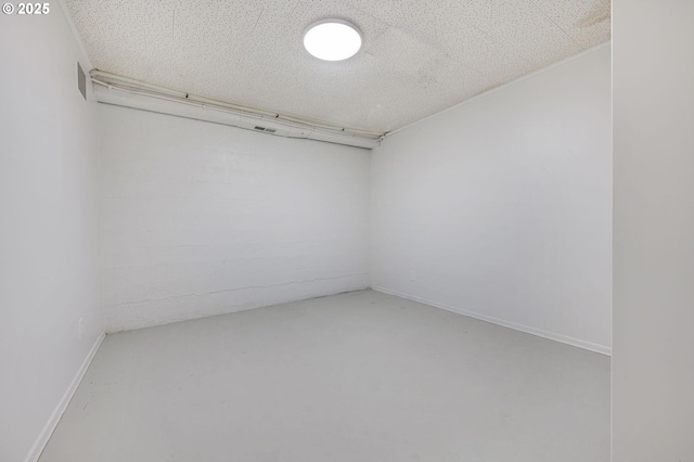 unfurnished room with concrete floors