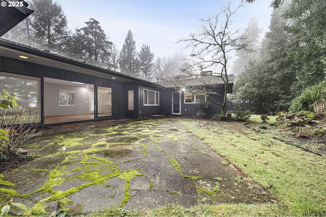 rear view of property with a patio area and a yard