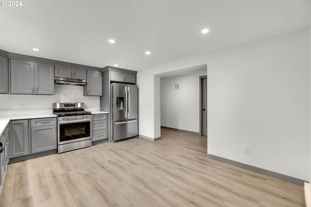 kitchen featuring appliances with stainless steel finishes, light hardwood / wood-style flooring, and gray cabinetry