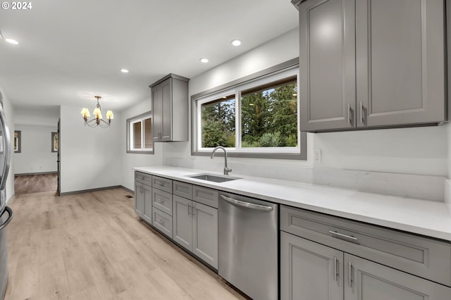 kitchen featuring stainless steel dishwasher, gray cabinetry, and light hardwood / wood-style floors