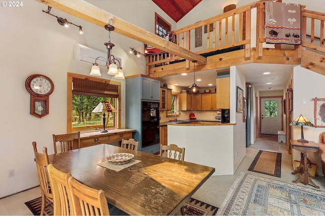 dining area featuring a wealth of natural light, sink, high vaulted ceiling, an AC wall unit, and a chandelier