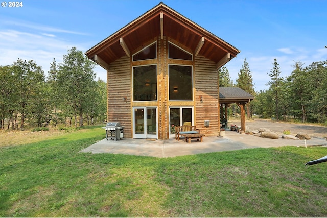 back of property featuring a lawn and a patio area