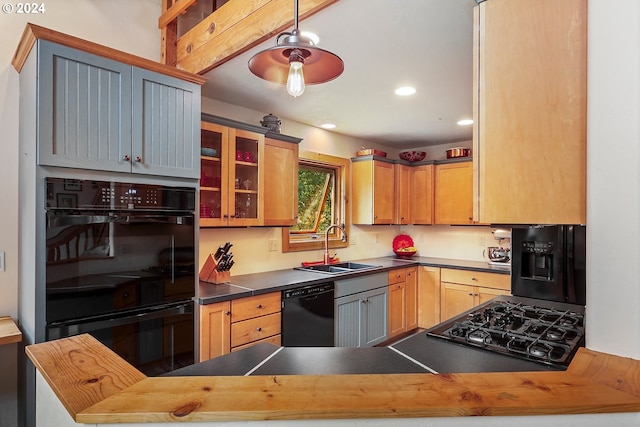 kitchen featuring black appliances, kitchen peninsula, butcher block counters, and sink