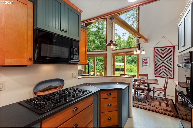 kitchen featuring kitchen peninsula, black appliances, decorative light fixtures, and an inviting chandelier