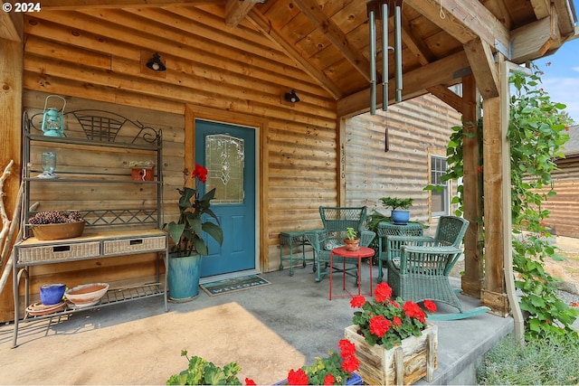 view of exterior entry with covered porch