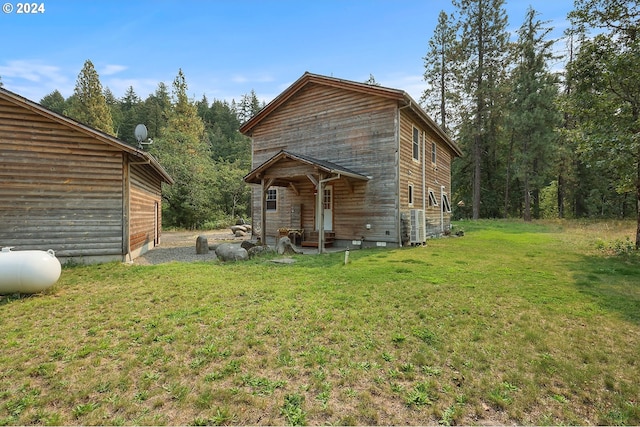 back of house with a lawn