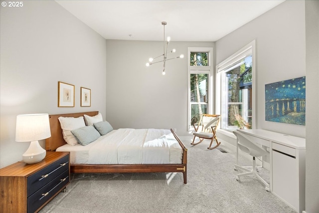carpeted bedroom with an inviting chandelier