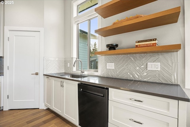 kitchen with sink, white cabinetry, black dishwasher, tasteful backsplash, and light hardwood / wood-style floors