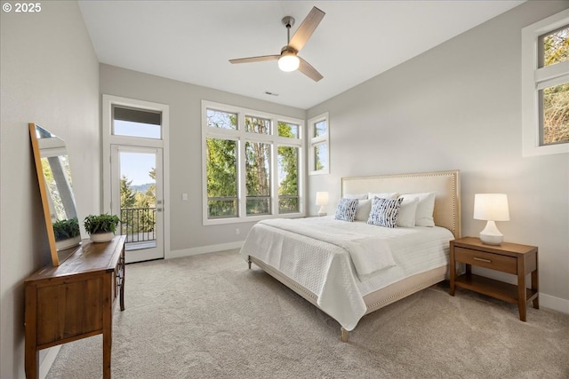 carpeted bedroom with baseboards, access to outside, and multiple windows
