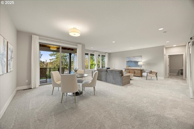 dining room with baseboards, recessed lighting, and light colored carpet
