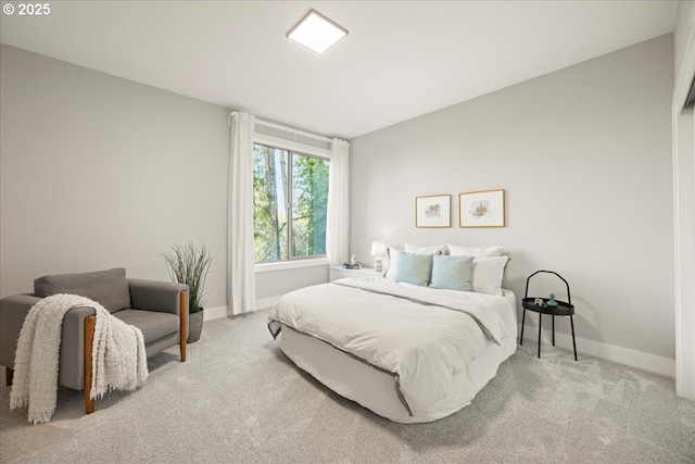 carpeted bedroom featuring baseboards