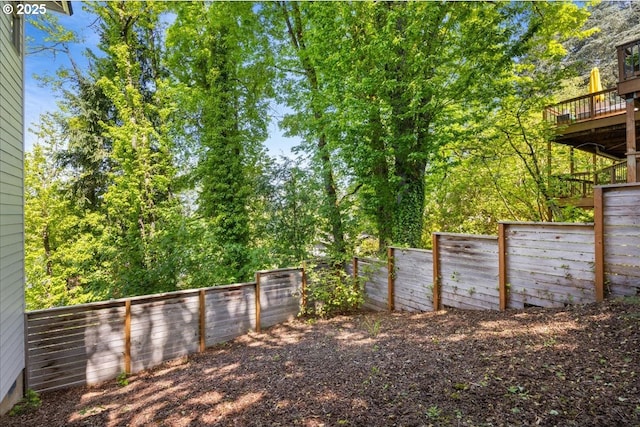 view of yard featuring a fenced backyard and a deck