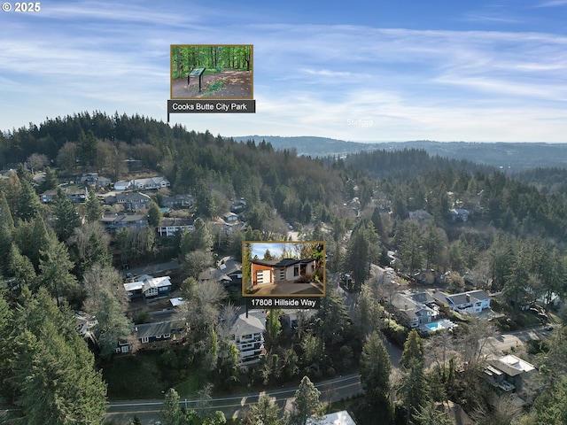 birds eye view of property with a forest view