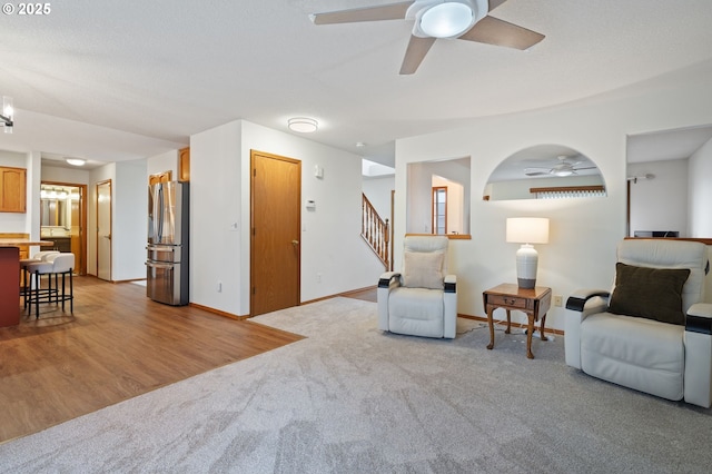 carpeted living room featuring ceiling fan