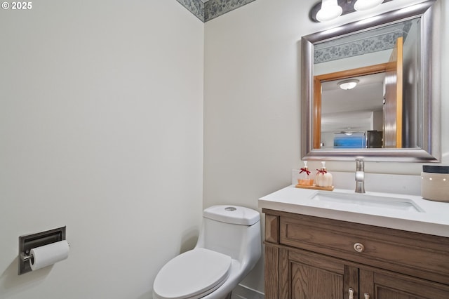 bathroom featuring vanity and toilet