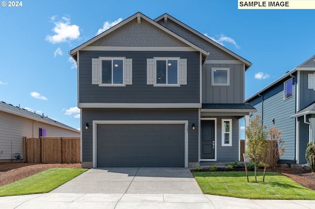 view of front of property with a garage and a front lawn