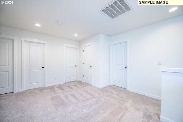 unfurnished bedroom with light colored carpet