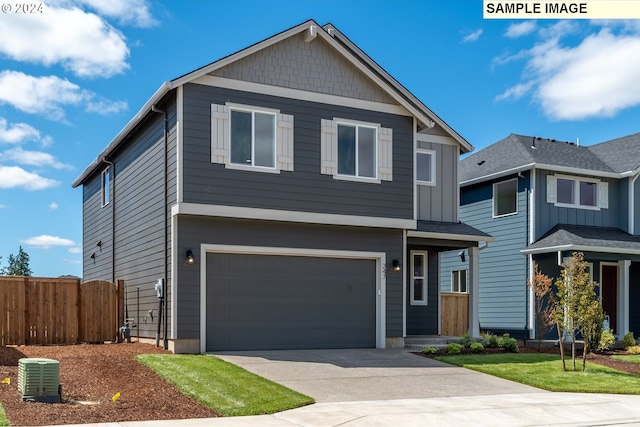 view of front of property with central AC unit and a garage