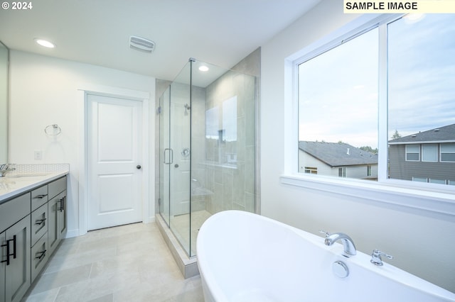 bathroom with vanity, tile patterned floors, and independent shower and bath