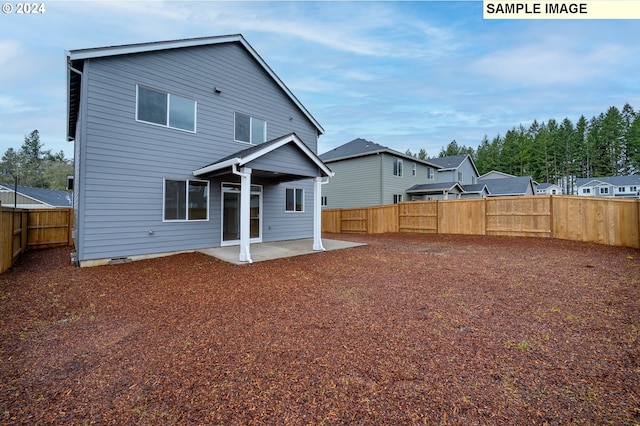 rear view of property featuring a patio area