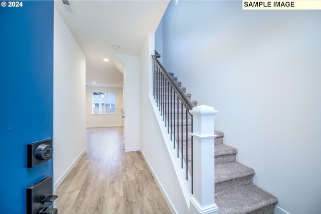 stairway featuring wood-type flooring