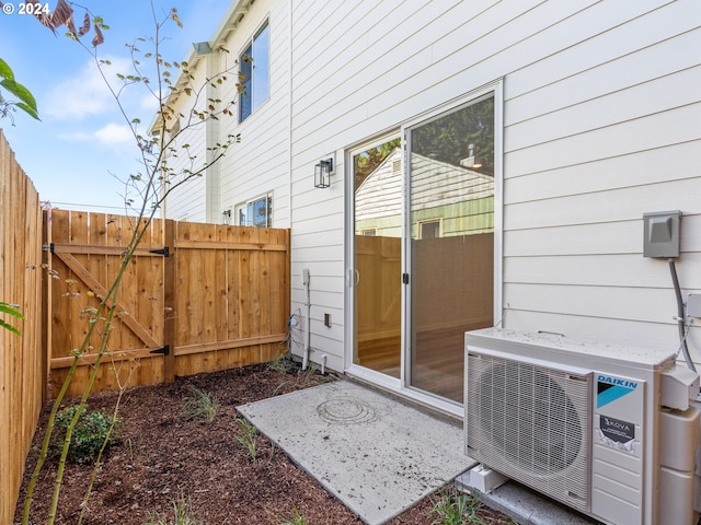 7471 N New York Ave Unit 3, Portland, OR 97203 - view of exterior entry featuring a gate, ac unit, and fence